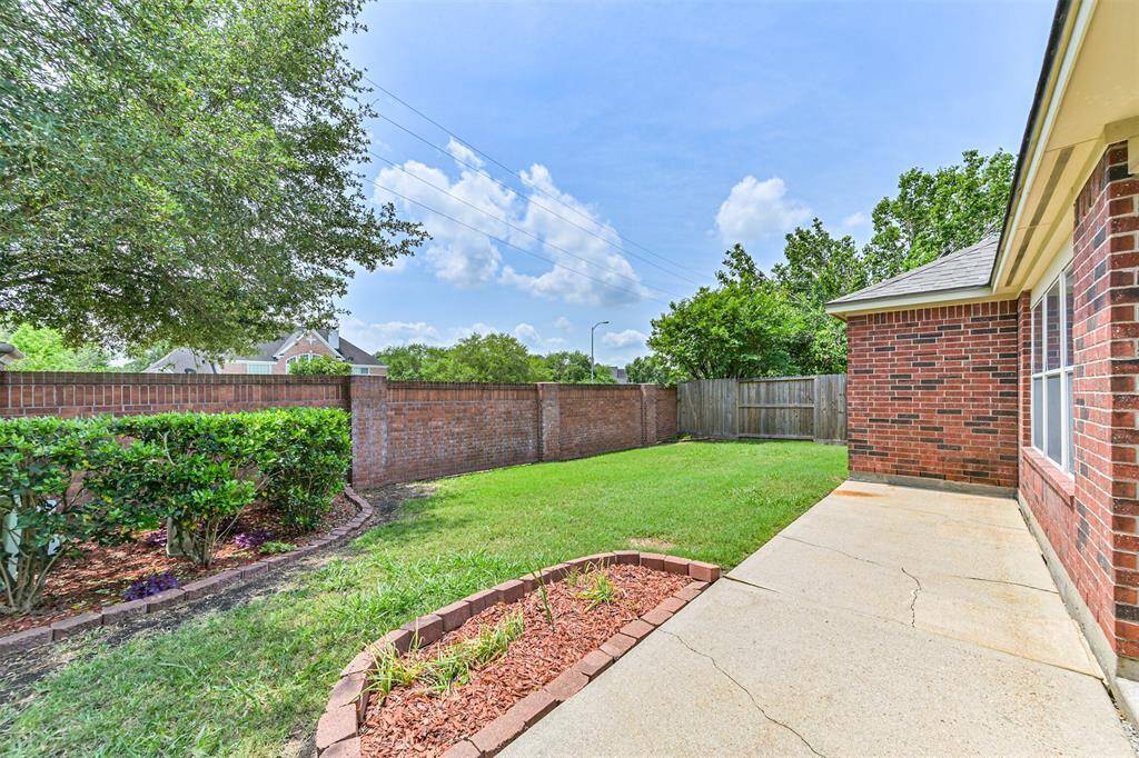 Backyard has no neighbors to the rear, features a brick wall for privacy