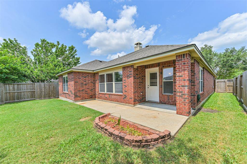 Charming brick home with a spacious, well-maintained backyard. Features a patio area, privacy fence, and lush greenery, perfect for outdoor relaxation or entertaining.
