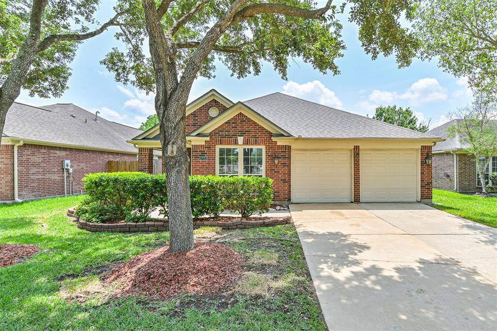 Charming single-story brick home with a welcoming front porch,