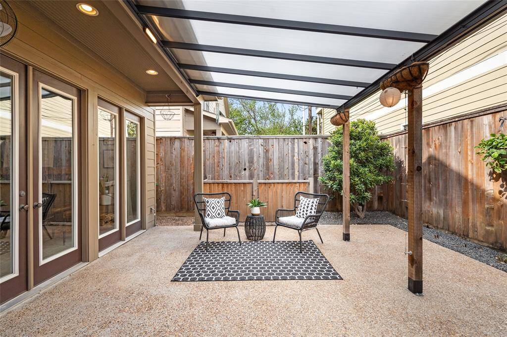 [Backyard]  This thoughtfully added covered pergola allows you to enjoy outdoor living year round