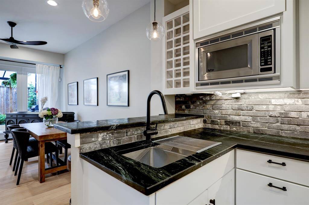 [Kitchen] Notice the large stainless steel double sink, beautiful soapstone counters and built in wine rack