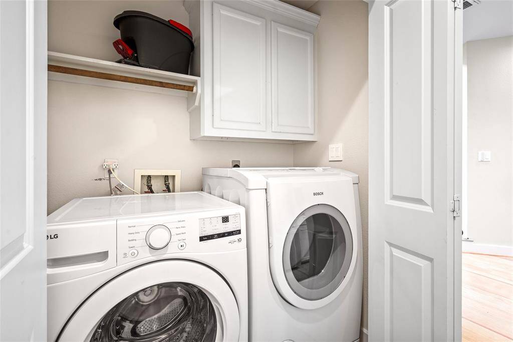 [Utility Closet] Located on the first floor, conveniently tucked away between the garage and the kitchen