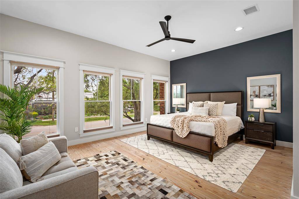 [Primary Suite] large bedroom exudes casual elegance and comfortable living... windows are equipped with remote controlled Hunter Douglas up/down shades