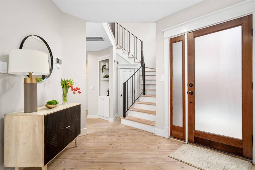 Step into an inviting foyer featuring beautifully refinished pinewood floors.