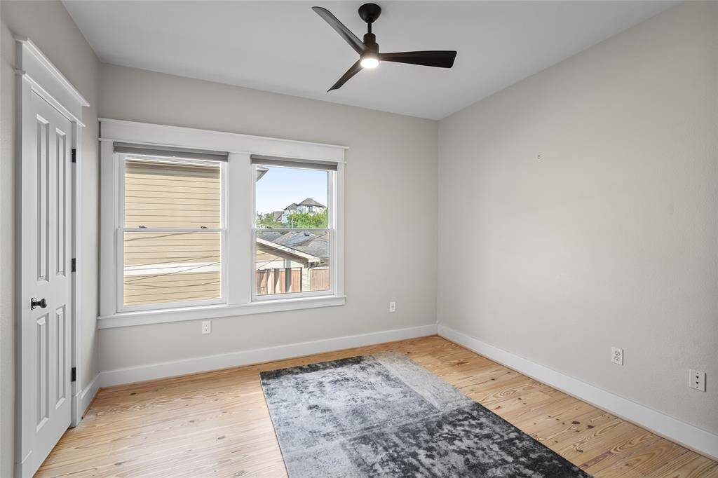 [Secondary Bedroom] Light filled space with Hunter Douglas shades and large closet