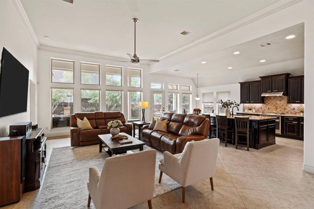 Enjoy incredible natural light and serene backyard views from the expansive family room, designed for both comfort and connection with its open-concept layout.