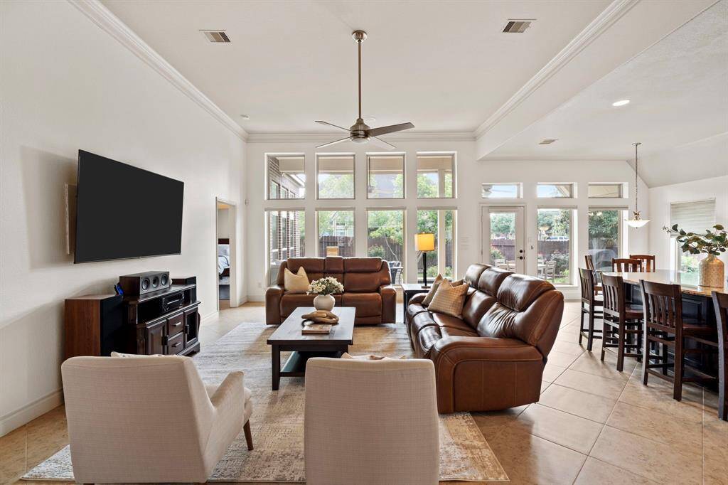 With its generous proportions, tile flooring, and sightlines to the dining area and breakfast space, this family room is the ultimate hub for everyday living and entertaining.