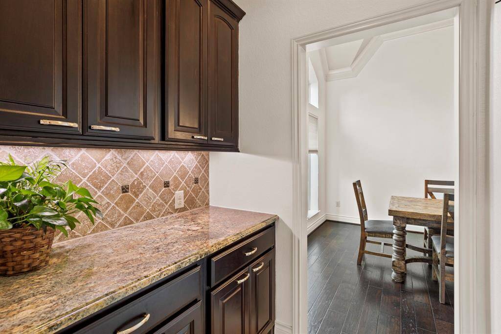 Positioned right next to a large walk-in pantry, the butler's pantry offers even more counter space and cabinet storage, ideal for serving or staging.
