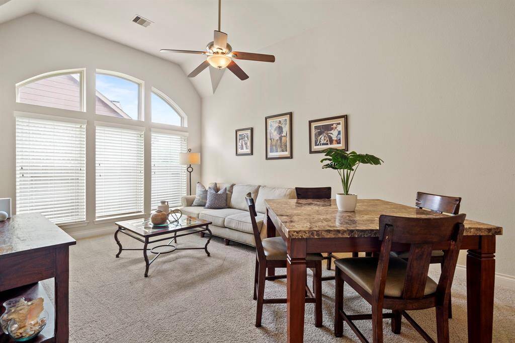 The light-filled game room offers vaulted ceilings, arched windows, and plenty of space to relax, play, or entertain.