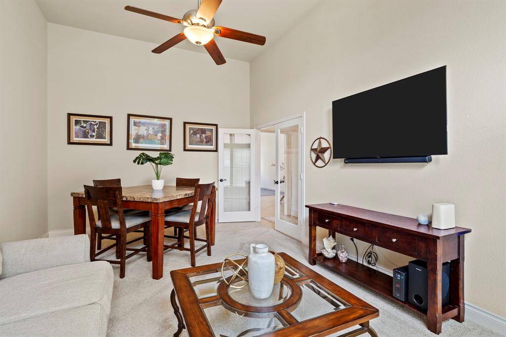 This flexible room is perfect as a game room or second living area, offering an inviting space for lively game nights or quiet evenings, with direct access to the guest suite and hallway.