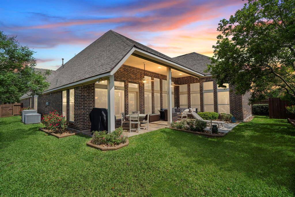 As the sun sets, your private backyard transforms into a peaceful retreat with soft lighting and vibrant flower beds setting the tone for unforgettable evenings.