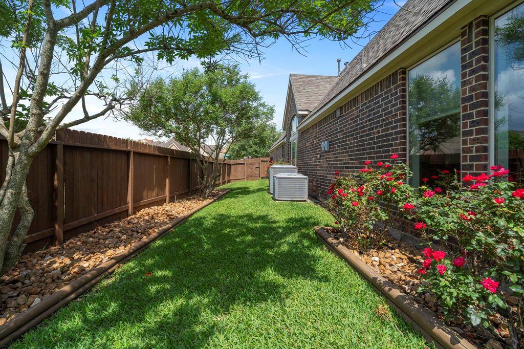 A generous side yard provides added green space for play or gardening, with easy access to both the backyard and front of the home.