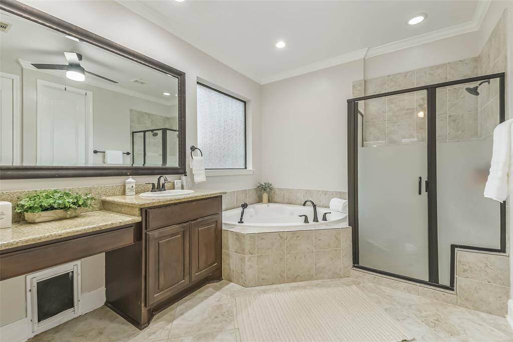 Large full bathroom with corner tub and large separate shower.