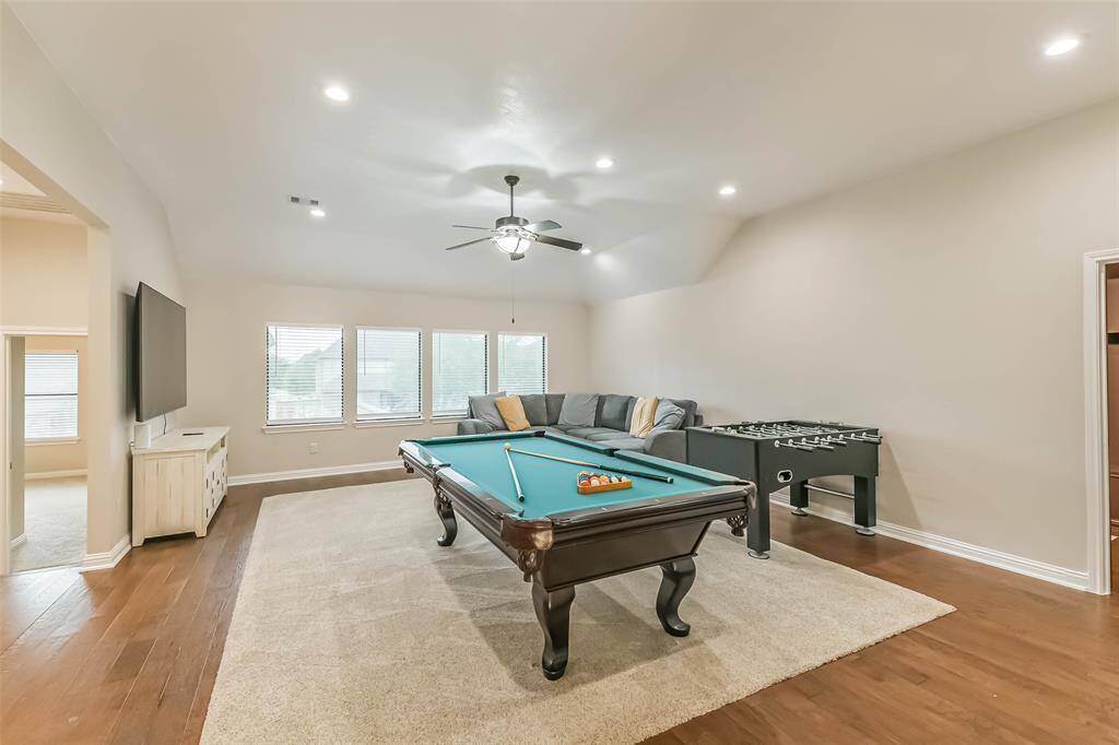 Open game room with media room on side.