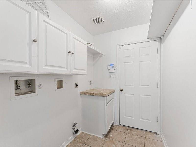 Laundry Room with Built in Cabinets with Garage Access
