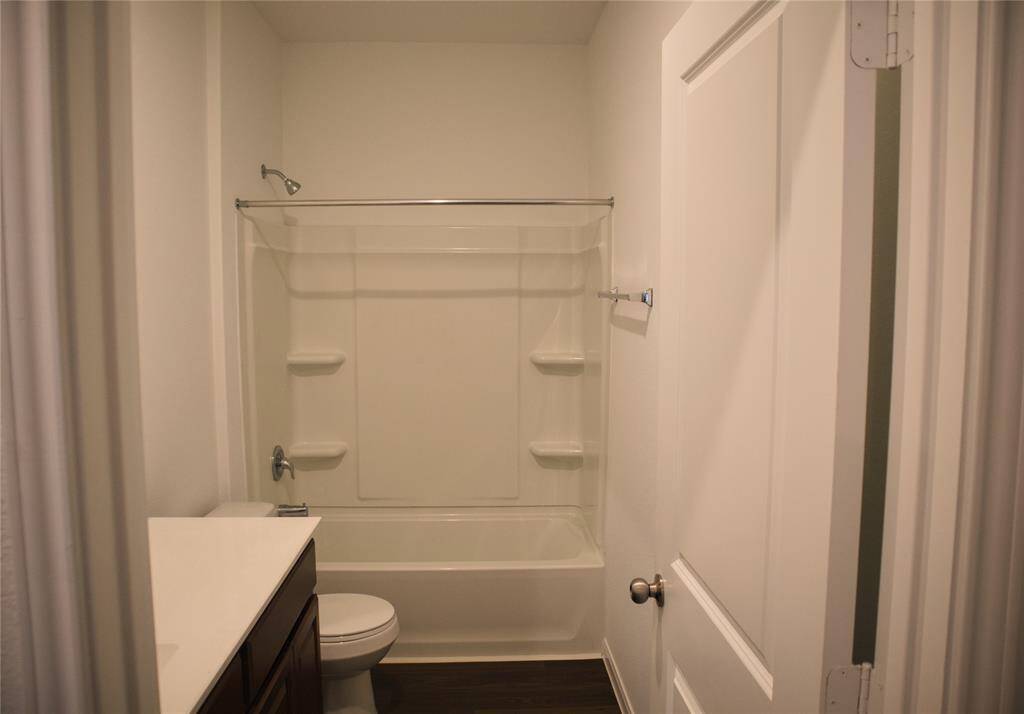 A tub shower combo in the secondary bath