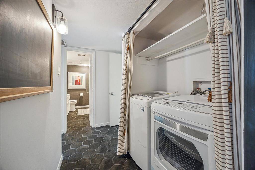 Off the kitchen is a hallways separating the bedrooms from the living spaces. Here you will find the washer and dryer. The primary is to the right and the secondary bedroom is to the left.