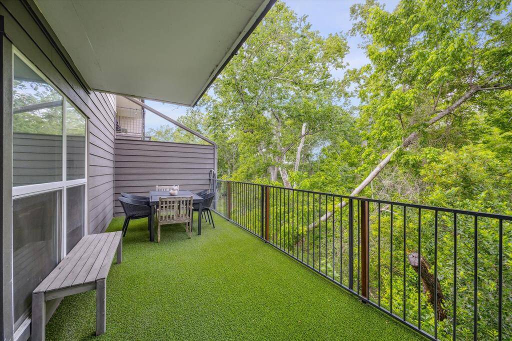 The patio continues past the primary bedroom. Greenery continues the whole way down!
