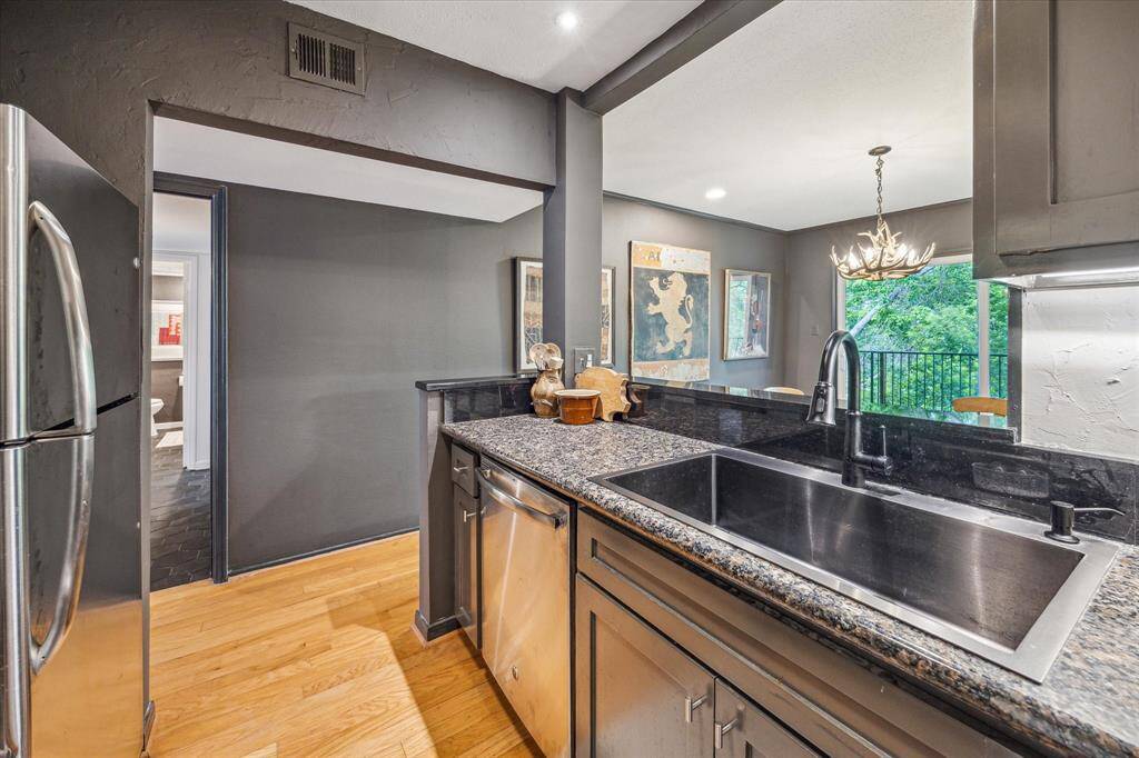 The kitchen is situated conveniently between the living room and dining room. The kitchen was redone including opening up the wall above the counter and a recently installed black steel farmhouse sink.