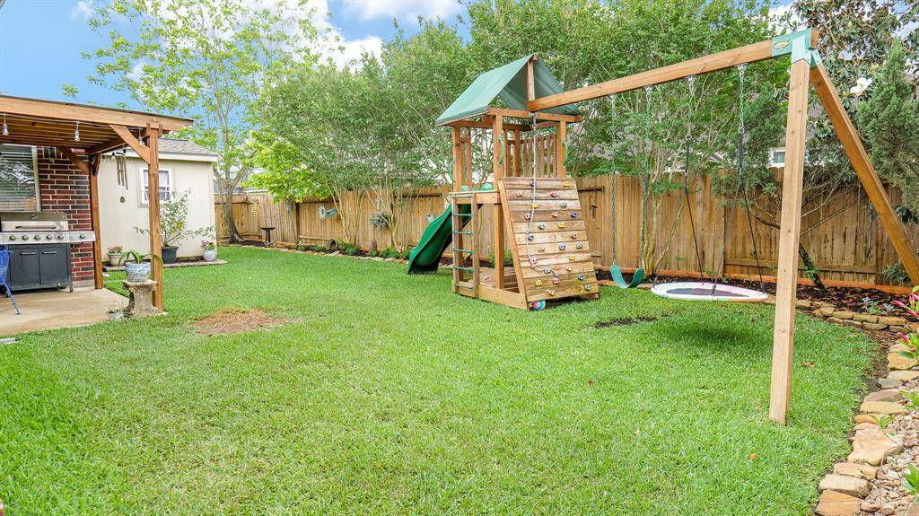 The backyard is lined with trees for privacy and beauty. There is ample room to run and play.