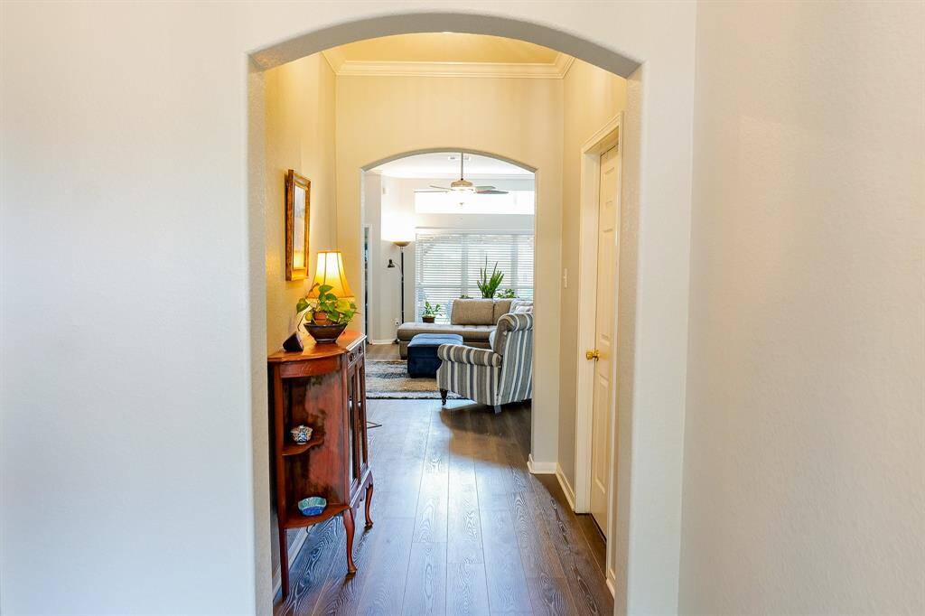 Standing in the lovely foyer you will see the hall leading to the den and common areas of the house. On the left is a hall to the secondary bedrooms.