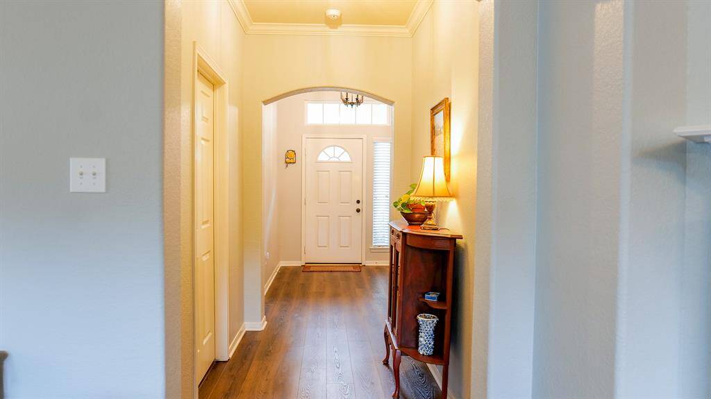 Here is view from the den, looking back towards the foyer and front door. Notice the transom and side windows giving both light and privacy.