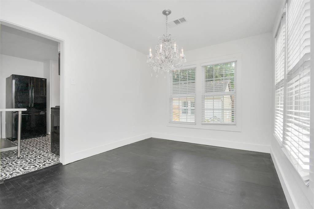 Open concept living and dining room with a beautiful chandelier.  Adjacent to the dining room is the kitchen and private balcony.