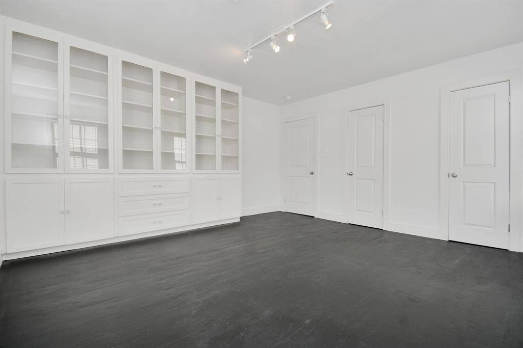 To the left of the entry is a hallway that leads to the bedrooms and bathroom.  Beautiful built-in storage unit in the back bedroom, in addition to ample closets.