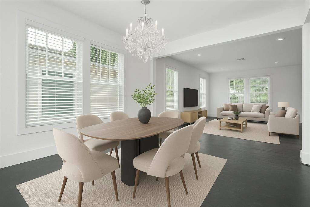 Virtually Staged Dining room with gorgeous chandelier, just off the kitchen and connected to the living room. Also could be used for a home office. Faux-Wood shutters.
