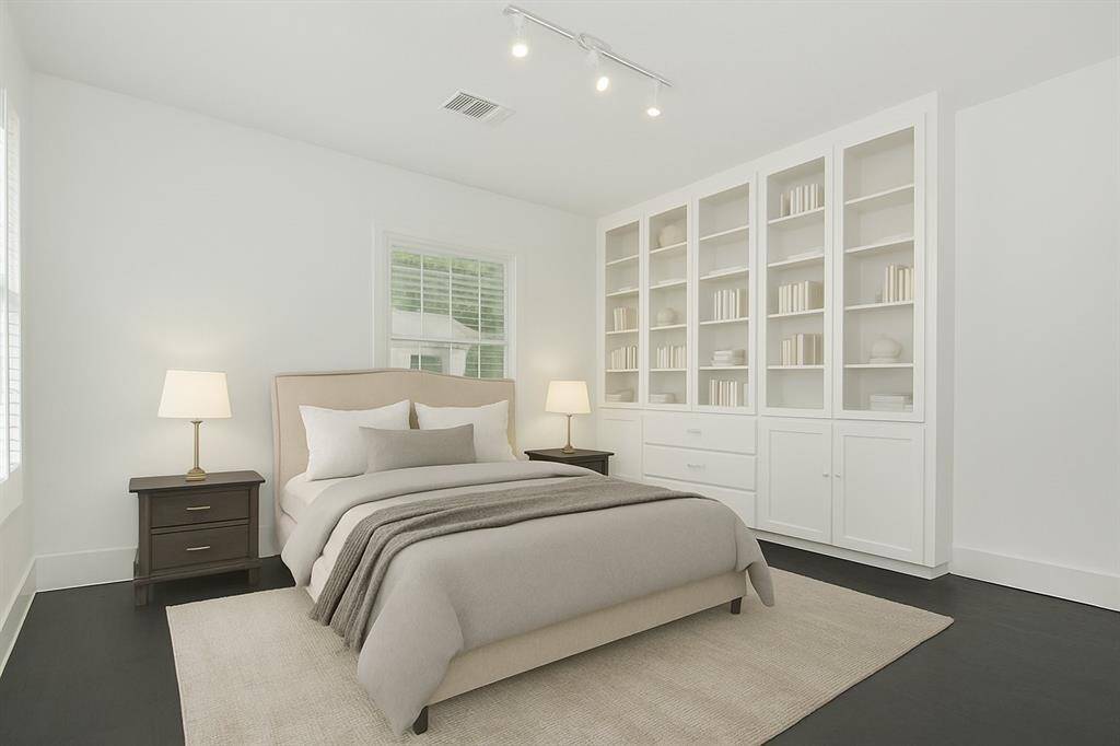 Virtually Staged Bedroom in the back, typically used as the primary bedroom as it has 2 closets and extra built-in storage