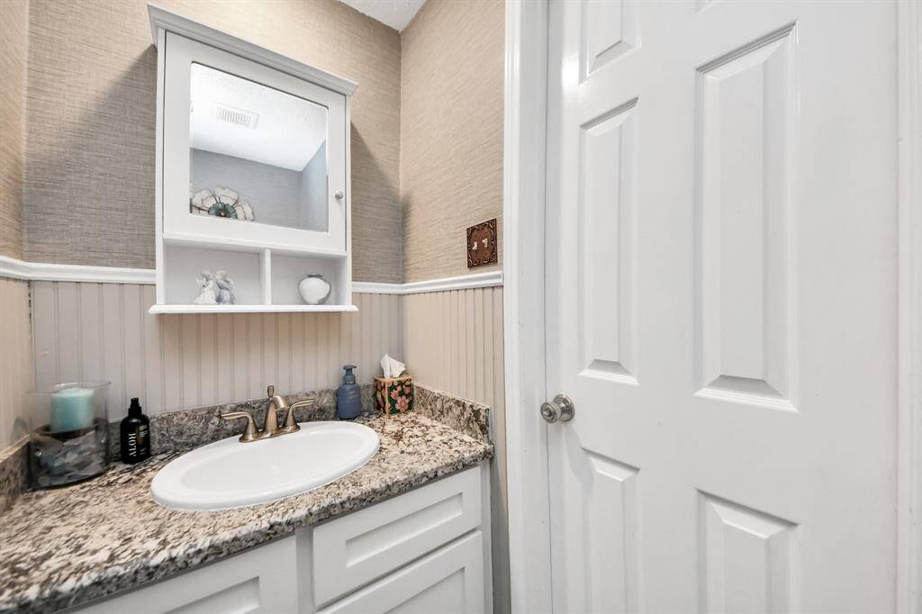 Convenient half bath downstairs, perfectly located near the back door and great for guests coming in from the pool."