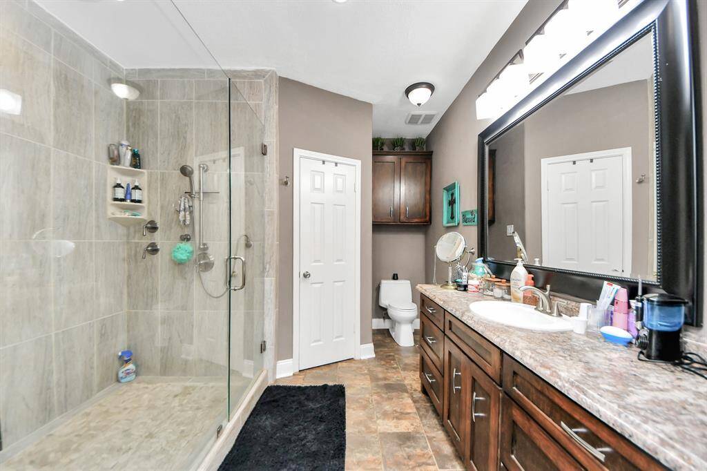 The primary bathroom features a spacious new shower with built-ins.
