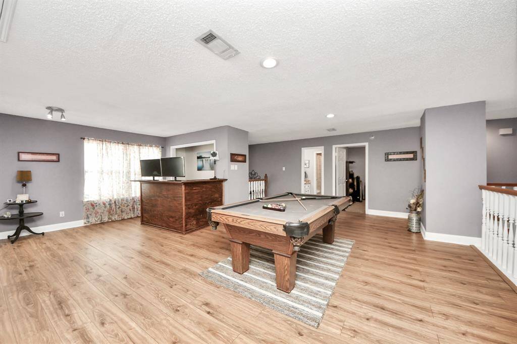 The game room also features a built-in bar for entertaining, with plenty of space left for a playroom or home office if needed.