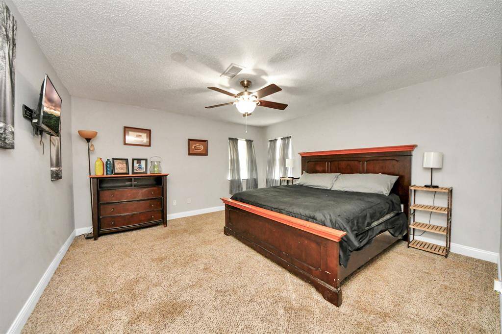 First spacious secondary bedroom with a large closet, offering plenty of room for storage and comfort.