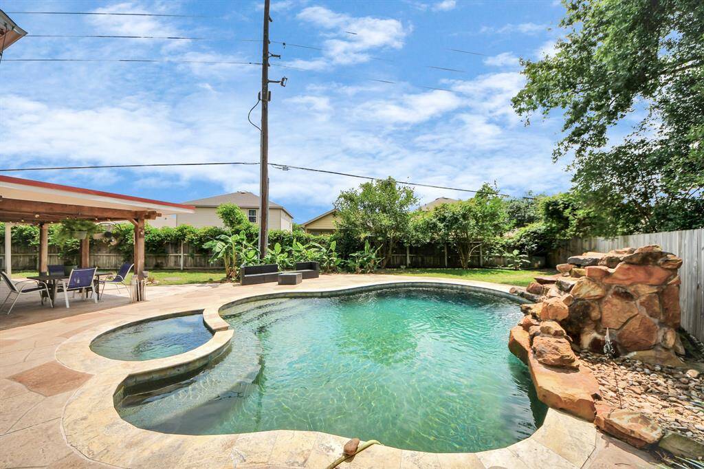 Gorgeous pool with a built-in hot tub for the ultimate backyard retreat.