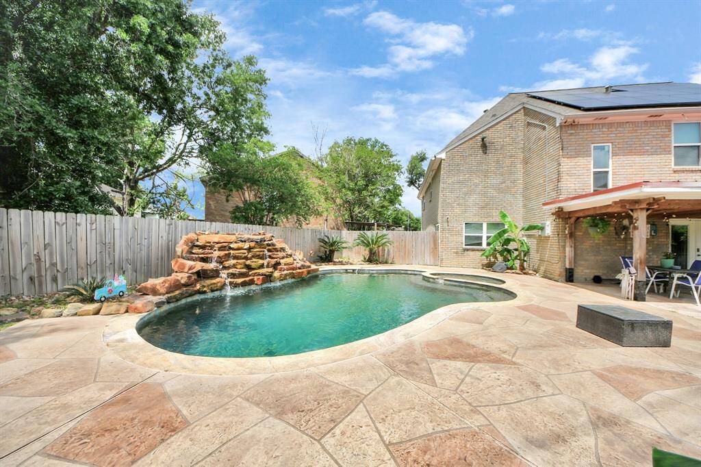 Beautiful pool with a stunning water feature, creating a relaxing oasis in your own backyard.