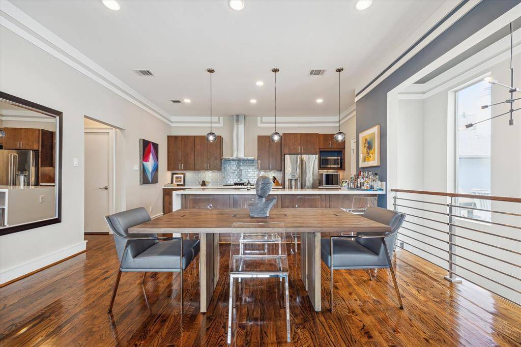 Good sized dining area. Notice the opening on the right with wrought iron railing looking down to the first floor and dramatic architectural windows bringing in so much natural light.