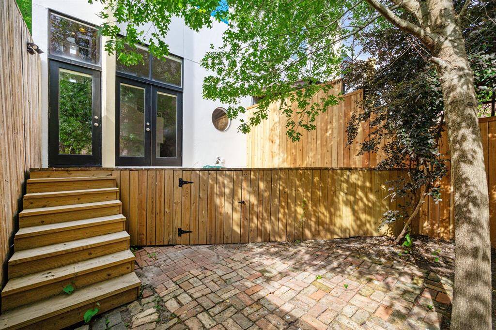 Reverse view, back yard to deck, living room through doorways.