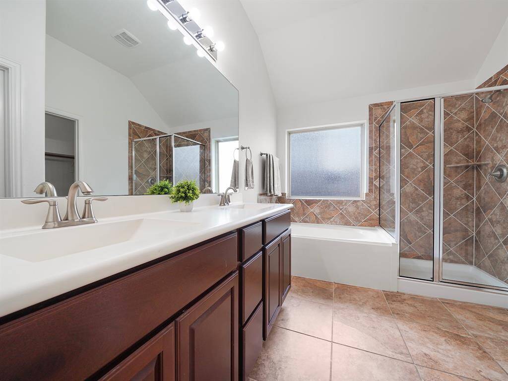 En-suite with dual sinks large garden tub, separate shower and walk in closet