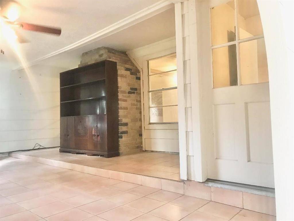 On the other side of the den is the enclosed former back patio which connects to the den & the laundry rm