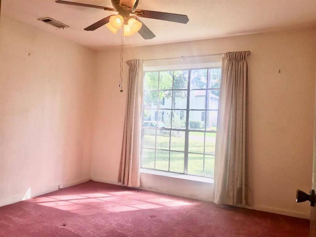 Another view into the 1st floor 2nd bed rm with large windows to the front yard