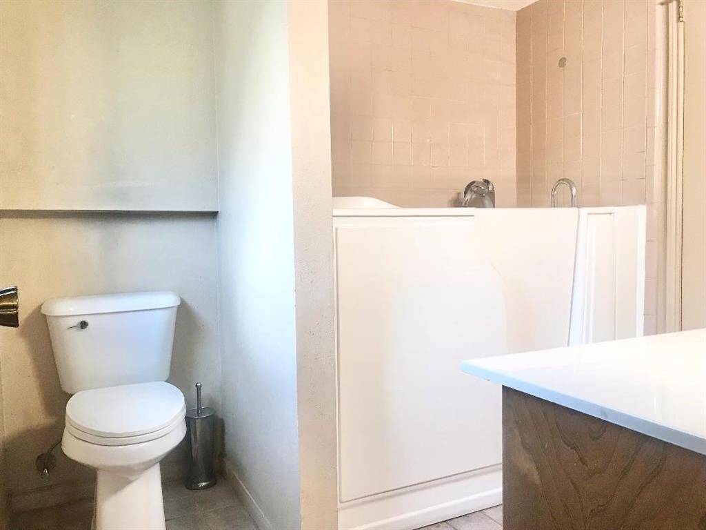 1st floor hall bath with direct access from the primary bed rm.