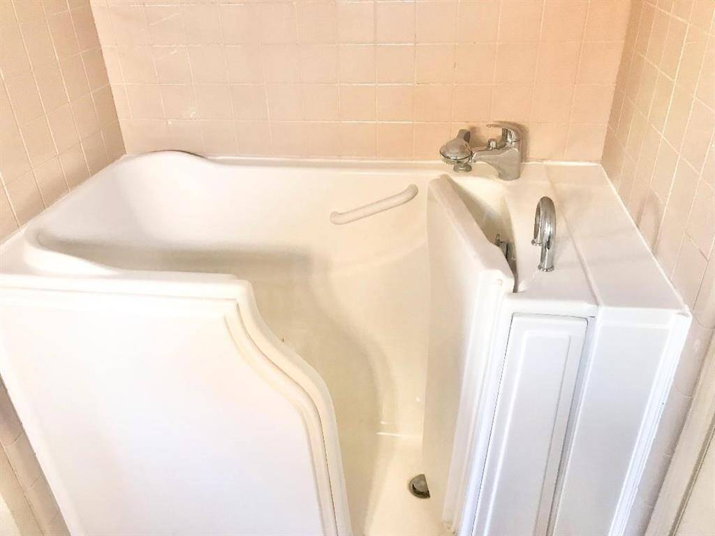 1st floor bath has a walk in tub with hand held shower