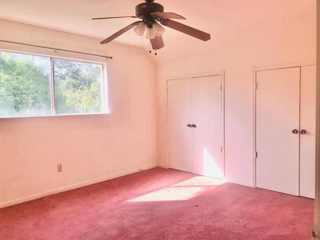 Left corner upstairs bedroom boasts a wall of closets