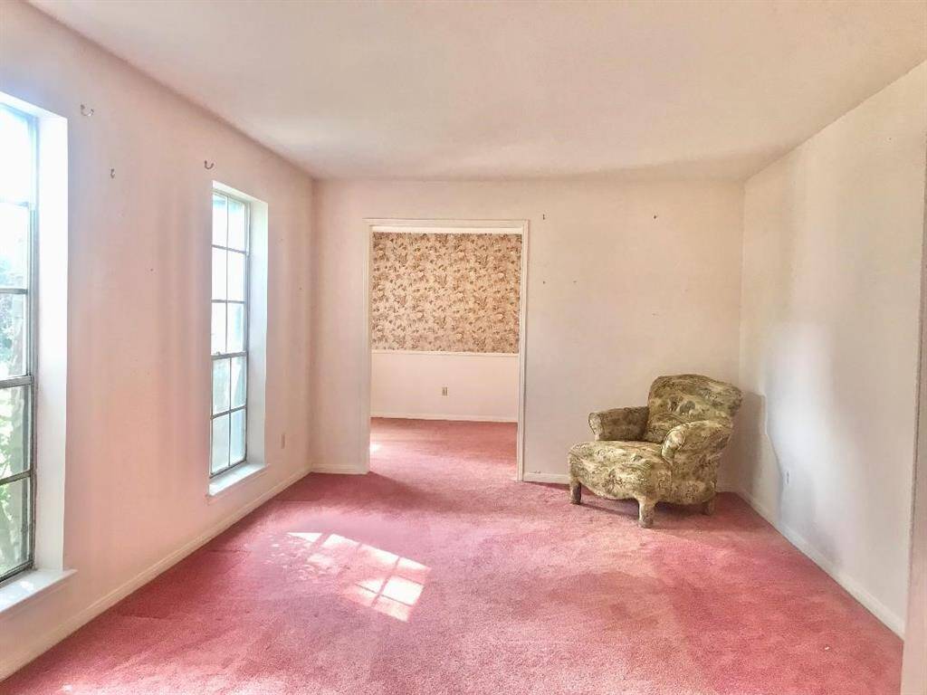 View from front entry into the living rm with the dining room at back which connects to the kitchen