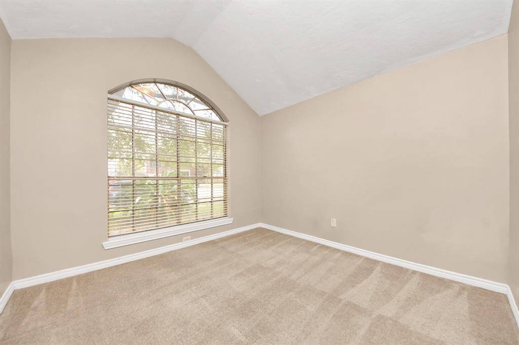 Designed with both style and function in mind, this third bedroom offers ample space.