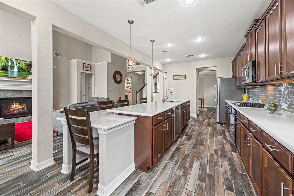 Now into the kitchen. Counter space galore! Look at the designer detail of the expanded island.  It's an easy gathering spot for friends while you create the meals in the kitchen!