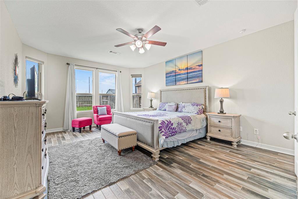 Now into your primary suite. This is a large space to create your own private retreat. The continued wood-like tiles floor adds that airy feel to the space.
