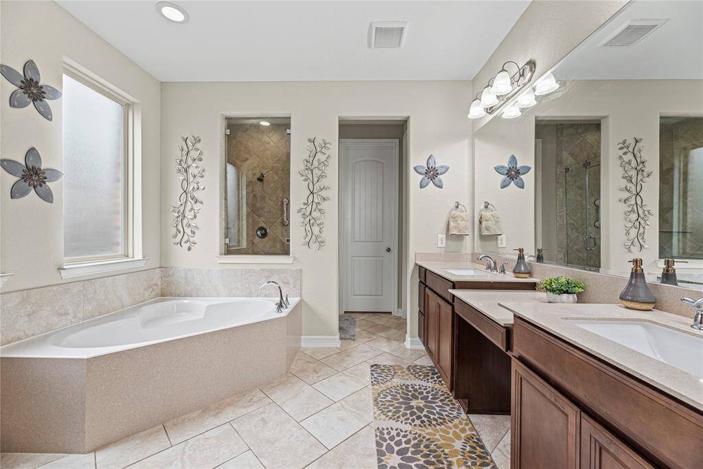 The primary bath might be bigger than your first apartment. There is so much space to get ready with separate vanities and plenty of room to move around!