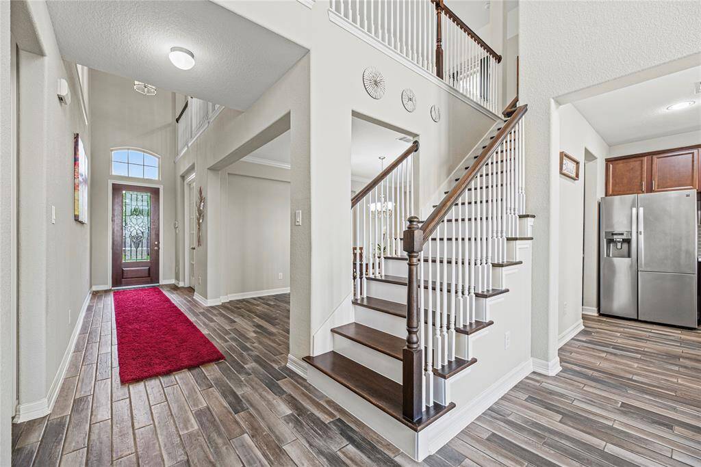 Tiled wood-like flooring is beautiful and functional.  It captures all the natural light and warms the whole first floor with a comforting feel.